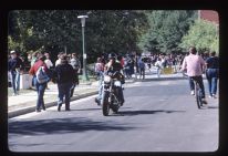 Students riding motorcycles and bikes to class